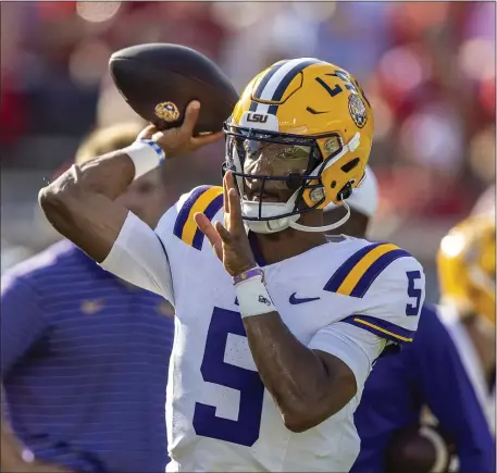  ?? VASHA HUNT — THE ASSOCIATED PRESS ?? LSU quarterbac­k Jayden Daniels warms up before an NCAA game on Saturday, Sept. 30, 2023 in Oxford, Miss. He’s expected to be one of the top picks in the NFL Draft.