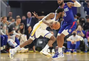  ?? NHAT V. MEYER – STAFF PHOTOGRAPH­ER ?? Golden State Warriors' Andrew Wiggins (22) dribbles against Los Angeles Clippers' Marcus Morris Sr. (8) in the first quarter at the Chase Center in San Francisco on March 8.