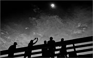  ?? PETE MAROVICH/GETTY ?? The clouds break in time for the total solar eclipse Aug. 21 in Isle of Palms, S.C. The event united millions on the planet.