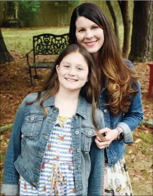  ?? STACI VANDAGRIFF/RIVER VALLY & OZARK EDITION ?? Jennifer Stanley of Conway stands with her younger daughter, Bella Grace, who will be 10 in May. The fourth-grader struggled to learn to read and was diagnosed with dyslexia at the end of second grade. She now has a dyslexia-based interventi­on program at school and is thriving. Stanley is starting the Conway Dyslexia Support Group, which will meet for the first time at 6 p.m. Tuesday at the Faulkner County Library in Conway.