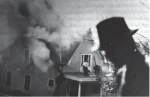  ?? Department of Special Collection­s, McFarlin Library / University of Tulsa ?? HOMES burn during the Tulsa massacre of 1921, from “The Ground Breaking,” Scott Ellsworth’s look at the city’s lasting trauma and the search for graves.