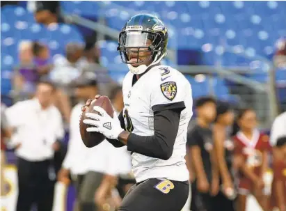  ?? KENNETH K. LAM/BALTIMORE SUN ?? Robert Griffin III, whose regular-season roster spot is one of the Ravens’ biggest decisions, warmed up before the final preseason game against the Redskins on Thursday, but didn’t play as Lamar Jackson and Josh Woodrum shared the quarterbac­k duties.