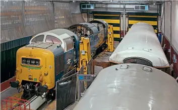  ??  ?? Class 55 Deltic No. 55022 Royal Scots Grey minus its power units that are being repaired. The fuel tanks are also away, being cleaned. The two carriages to the right are in for the fitting of retention tanks.