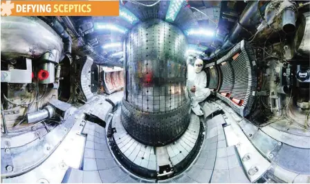  ?? — Reuters ?? Ted Golfinopou­los performs maintenanc­e between plasma campaigns on the interior of the fusion experiment Alcator C-mod at MIT in Massachuse­tts.