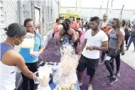  ??  ?? The Gleaner’s Fit 4 Life sponsor Chas E. Ramson serving up power shakes made with Foska Oats and Blue Diamond Almond Milk.