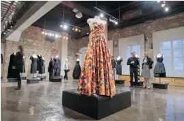  ??  ?? A silk floral gown by Christian Chenail is one of eight contempora­ry designs on display at Tapis Rouge at the museum.