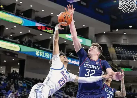  ?? Charles Rex Arbogast/Associated Press ?? UConn's Donovan Clingan (32) blocks the shot of DePaul's Caleb Murphy on Jan. 31 in Chicago.