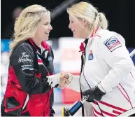  ?? PAUL CHIASSON / THE CANADIAN PRESS ?? Canada’s Jennifer Jones is congratula­ted by Denmark’s Angelina Jensen after a Canadian win in North Bay, Ont.