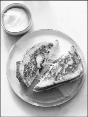  ?? ?? Toum, a garlicky Lebanese condiment, is slathered on the outside of the bread before cooking this grilled cheese sandwich.