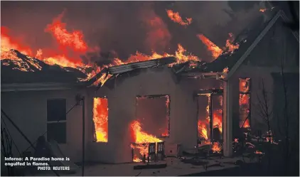  ??  ?? Inferno: A Paradise home is engulfed in flames.PHOTO: REUTERS