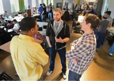  ?? RICHARD LAUTENS/TORONTO STAR ?? Chris Eben (with mentors Francis Yanga, left, and Rob Domagala) is the organizer of Toronto’s Startup Weekend. Eben says the program allows young people “to dip their toe” into entreprene­urship.