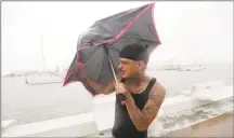  ?? Eric Gay / Associated Press ?? Chris Headen battles with his umbrellas as Hurricane Hanna begins to make landfall, Saturday in Corpus Christi, Texas.