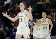  ?? MATTHEW HINTON — THE ASSOCIATED PRESS ?? Michigan guard Leigha Brown (32) celebrates a 3-point basket by forward Emily Kiser (33) in the first half of a first-round college game against UNLV in the women’s NCAA Tournament in Baton Rouge, La., on Friday.