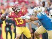  ?? SEAN M. HAFFEY/GETTY ?? USC quarterbac­k Caleb Williams looks to pass under pressure from UCLA’s Keanu Williams.