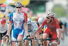  ?? CHRISTOPHE ENA THE ASSOCIATED PRESS ?? France’s Arnaud Demare, left, celebrates after he crosses the finish line first, completing a 171-kilometre leg of the Tour de France on Thursday.