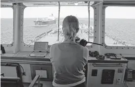  ?? James Nielsen / Houston Chronicle ?? Capt. Kristi Taylor pilots the oil tanker Pamisos. Ships cannot enter or leave the Houston Ship Channel without guidance from Taylor or one of her 96 colleagues, who have memorized the waterway.