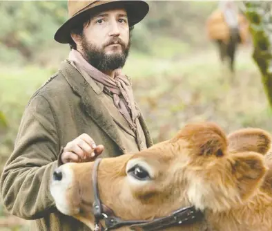  ?? ALLYSON RIGGS/A24 ?? John Magaro as Cookie Figowitz with Eve in First Cow