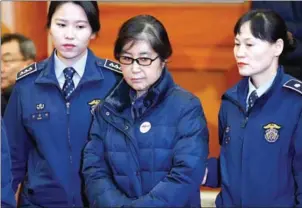  ?? KIM HONG-JI/AFP ?? Choi Soon-sil (centre), arrives at court in Seoul on January 16. Choi, the secret confidante of ousted South Korean President Park Geun-hye, was convicted yesterday.