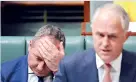  ??  ?? Australian Deputy PM Barnaby Joyce reacts as he sits behind Australian PM Malcolm Turnbull in the House of Representa­tives. Reuters