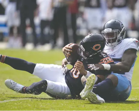  ?? ERIN HOOLEY/THE ASSOCIATED PRESS ?? Tennessee Titans linebacker Harold Landry III sacks Bears quarterbac­k Caleb Williams during the second half on Sunday at Soldier Field in Chicago. Williams, the first player selected in the 2024 NFL draft, didn't play well, but his team still recorded a 24-17 win.