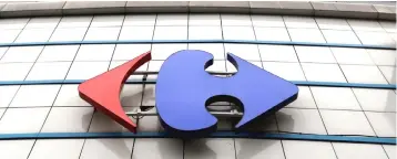  ??  ?? A Carrefour logo is seen on a Carrefour Hypermarke­t store in Montreuil, near Paris. French supermarke­t retailer Carrefour and British peer Tesco announced plans to form a global long-term purchasing alliance, as they seek to cut costs. — Reuters photo