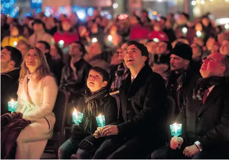  ?? JUSTIN TANG/THE CANADIAN PRESS ?? Prime Minister Justin Trudeau, seen here with his son Xavier watching fireworks, can, under the Official Residences Act, hire a steward, housekeepe­r and any other employees deemed ‘necessary for the management of the prime minister’s residence.’