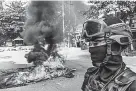  ?? Getty Images ?? Protesters set fire to tires in the street to slow the progress of security forces on Saturday in Yangon.