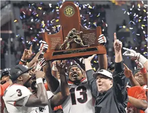  ?? DALE ZANINE/USA TODAY SPORTS ?? Georgia coach Kirby Smart celebrates with his team after winning the SEC title.