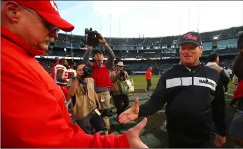  ??  ?? Kansas City Chiefs head coach Andy Reid, left, shakes hands with Oakland Raiders head coach Jon Gruden after an NFL football game in Oakland, Calif., Sunday. AP PhoTo/BEn mArgoT