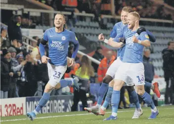  ??  ?? Joe Ward (left) after scoring the only goal of the game for Posh against Burton in November.