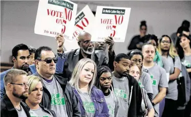  ?? Charlie Riedel / Associated Press ?? People rally at a church in Kansas City, Mo. In January, the City Council voted to rename one of the city's historic boulevards, The Paseo, after Dr. Martin Luther King Jr., but a referendum reversed that decision.