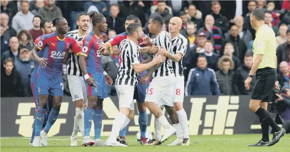  ??  ?? Crystal Palace’s Wilfried Zaha clashes with Kenedy during the stalemate at Selhurst Park.