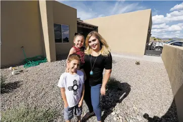  ?? LUIS SÁNCHEZ SATURNO/THE NEW MEXICAN ?? Amy Biehl Community School teacher Alyssa Maestas, pictured with her children, Maira Maestas, 3, and Stephen Maestas, 6, had to transition to teaching online for the last two months of the 2019-20 school year. She will continue to teach remotely in a few weeks because Santa Fe Public Schools last week opted to start the upcoming school with distance learning.