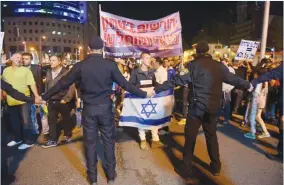  ?? (Avshalom Sassoni/Maariv) ?? RESIDENTS OF the South protest in Tel Aviv last night against the ceasefire with Hamas. Regional Cooperatio­n Minister Tzachi Hanegbi was attacked across the political spectrum for dismissing Hamas’s rocket attacks on Gaza Strip periphery communitie­s as ‘minor.’