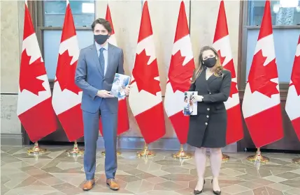  ?? REUTERS ?? Canada’s Prime Minister Justin Trudeau and Finance Minister Chrystia Freeland pose for a picture holding the budget on Parliament Hill in Ottawa on Monday.