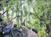 ?? AP FILE ?? A militant fires in the air in salute at the funeral of ‘commander’ Saddam Padder in Heff village, south of Srinagar, on May 6.