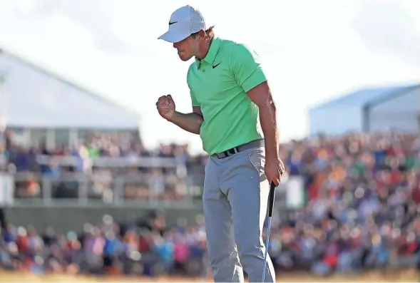  ?? RICK WOOD / MILWAUKEE JOURNAL SENTINEL ?? Brooks Koepka pumps his fist and celebrates his first major tournament victory at the 18th hole at Erin Hills. Koepka tied the U.S. Open tournament scoring record with a 272.