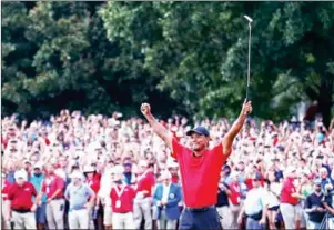  ?? TIM BRADBURY/GETTY IMAGES/AFP ?? Tiger Woods celebrates making a par on the 18th green to win the Tour Championsh­ip at East Lake Golf Club on Sunday in Atlanta, Georgia.
