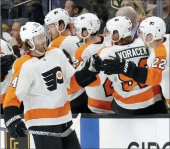  ?? ISAAC BREKKEN — THE ASSOCIATED PRESS ?? Flyers center Sean Couturier shakes hands with the bench after a period of Sunday’s 4-1 win over Golden Knights in Las Vegas. goal during the second