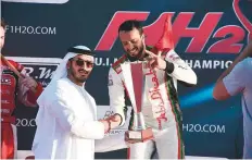  ?? Courtesy: Organisers ?? Shaikh Mohammad Bin Sultan Bin Khalifa Al Nahyan, VicePresid­ent and CEO of Abu Dhabi Internatio­nal Marine Sports Club hands the Grand Prix of Abu Dhabi trophy to Al Qamzi.