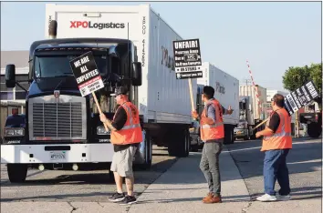  ?? Mark Boster / TNS ?? Port truck drivers picket at a XPO Logistics facility in Commerce, Calif., in 2017. A federal judge in California has given preliminar­y approval to two settlement­s of class-action lawsuits against XPO that would total nearly $30 million.