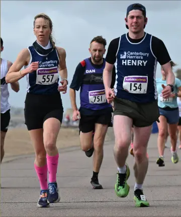  ?? Picture: Barry Goodwin ?? Canterbury Harriers runners Lucie Parker and Henry Cox hit the seafront at Hythe in last Friday’s Folkestone 10-mile race. Athletics, page 34