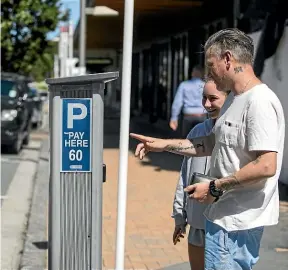  ?? GEORGE HEARD/STUFF ?? Between 60 and 70 per cent of people in Christchur­ch didn’t bother using public transport at all in the past 12 months. Martin Exon is one of those residents. Here, he feeds money into a parking machine with his daughter Daisy Exon.