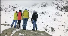  ?? Photograph: LMRT. ?? A member of the Scottish Avalanche Informatio­n Service, two family members and a representa­tive of the Swiss Alpine Club below the scene of the incident.