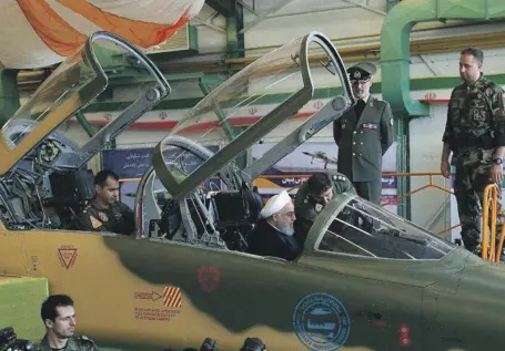  ?? Reuters ?? Iranian President Hassan Rouhani is shown around the cockpit of newly unveiled Kowsar fighter jet in Tehran