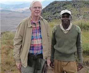  ??  ?? Welcome: Philip and guide Simeon on Zimbabwe’s Mt Nyangani