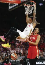  ?? JOHN LOCHER — THE ASSOCIATED PRESS ?? The Phoenix Mercury’s Brittney Griner, of Team Delle Donne, dunks over the Las Vegas Aces’ Liz Cambage, of Team Wilson, during the first half of a WNBA All-Star Game on July 27 in Las Vegas.