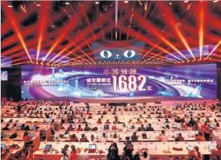  ?? /Getty Images ?? Celebratio­n: The screen in Shanghai as Alibaba tops 168.2-billion yuan in sales on Sunday. The online event kicked off with a gala concert featuring Mariah Carey.