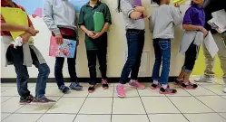  ?? AP ?? Migrant teens line up for a class at a ‘‘tender-age’’ facility for babies, children and teens, in Texas’ Rio Grande Valley, in San Benito.