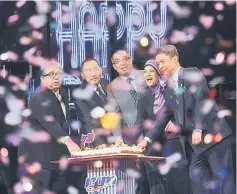  ??  ?? Salleh (centre) cutting a cake in conjunctio­n with the 71st RTM Day at Angkasapur­i in Kuala Lumpur. — Bernama photo